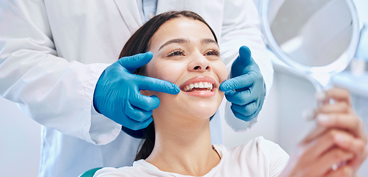 gloved hands framing woman's smile