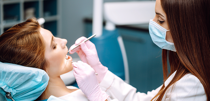 Dentist performing root canal treatment on a patient
