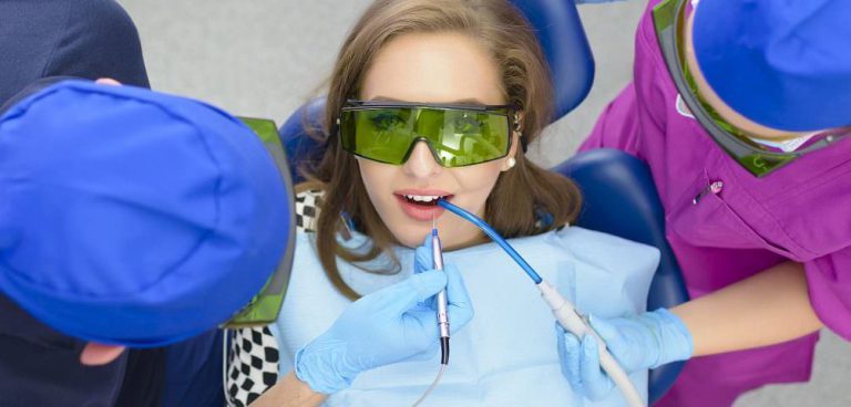 Patient in protective goggles during a laser whitening treatment