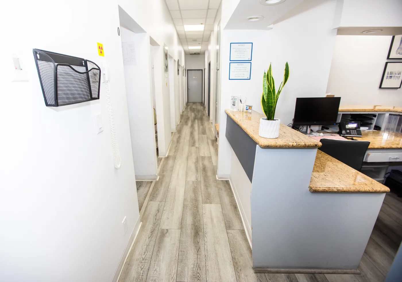 The corridor between operatories, looking past the front desk