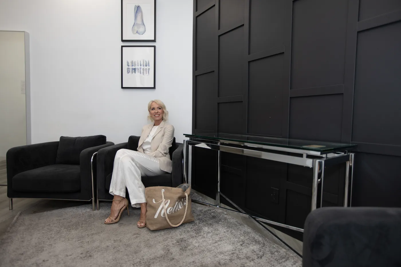 A patient waiting on the black sofa in the Smile LA lounge