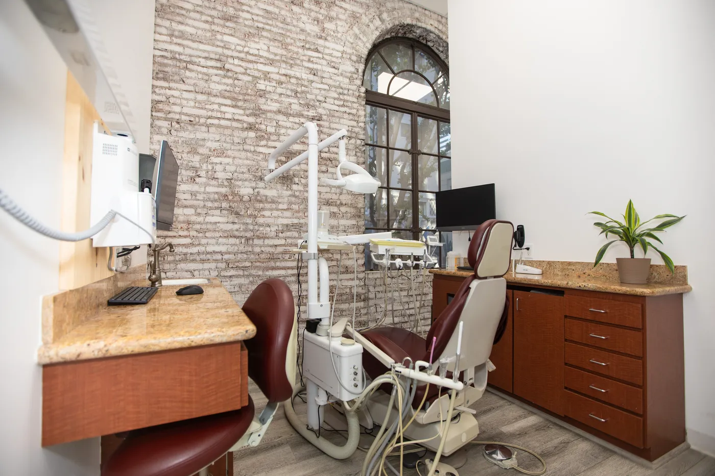 A treatment operatory with the original exposed brick wall and an arched window
