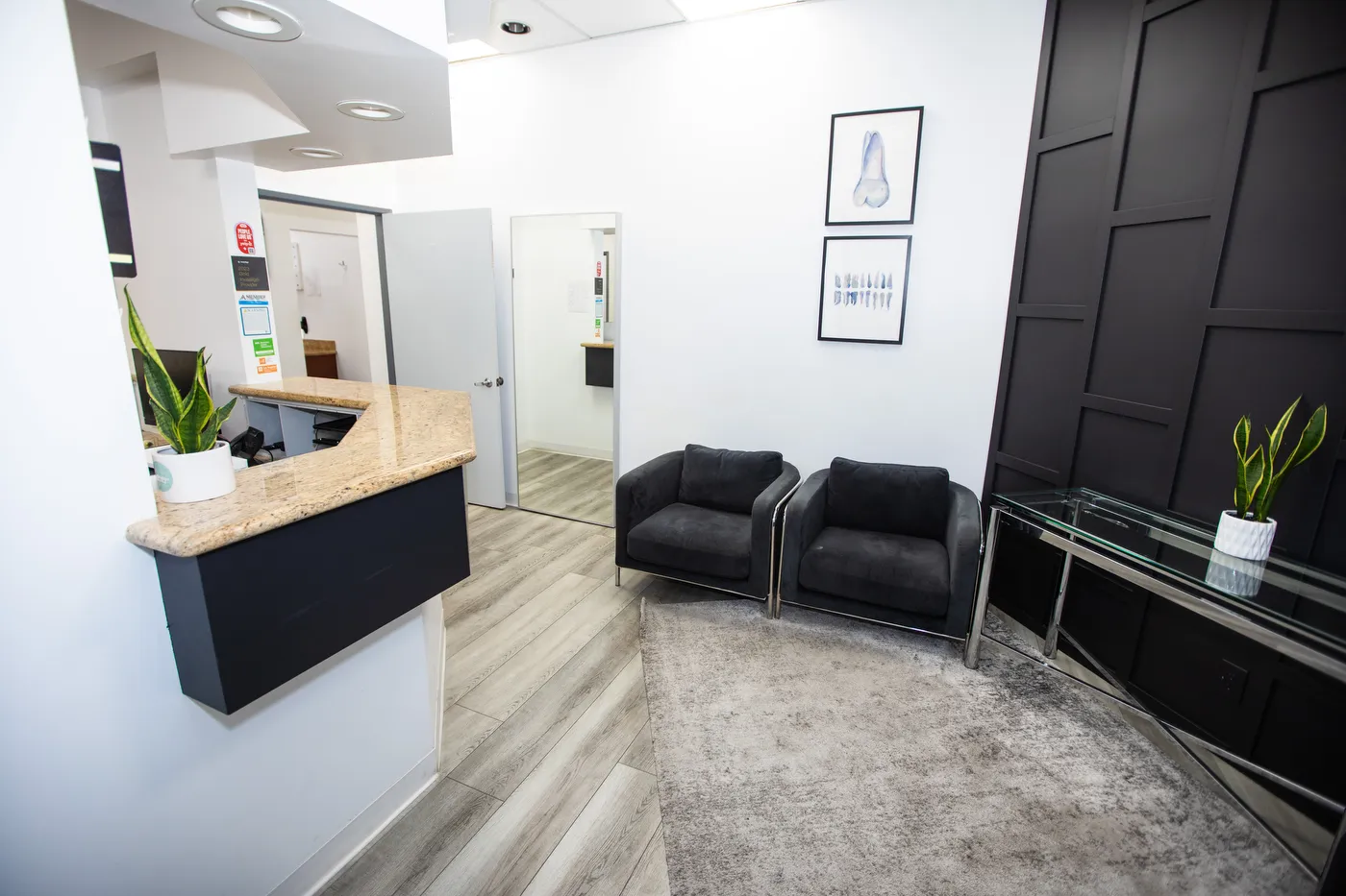 The reception desk and waiting area, with black armchairs beneath the arched windows