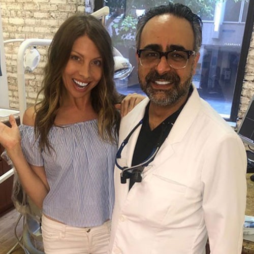 A patient standing with Dr. Kourosh Yousefzadeh after treatment