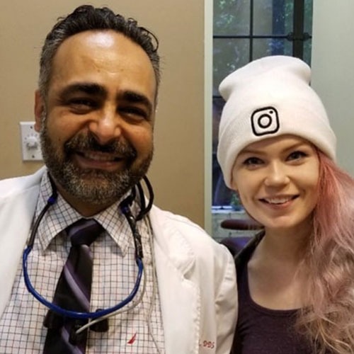 A patient standing with a Smile LA doctor after treatment