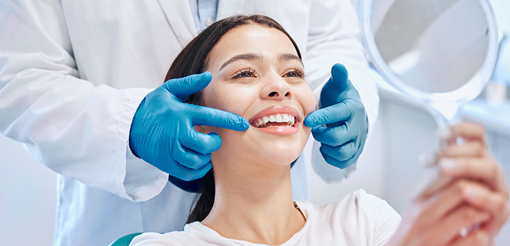 Gloved hands framing a woman's smile