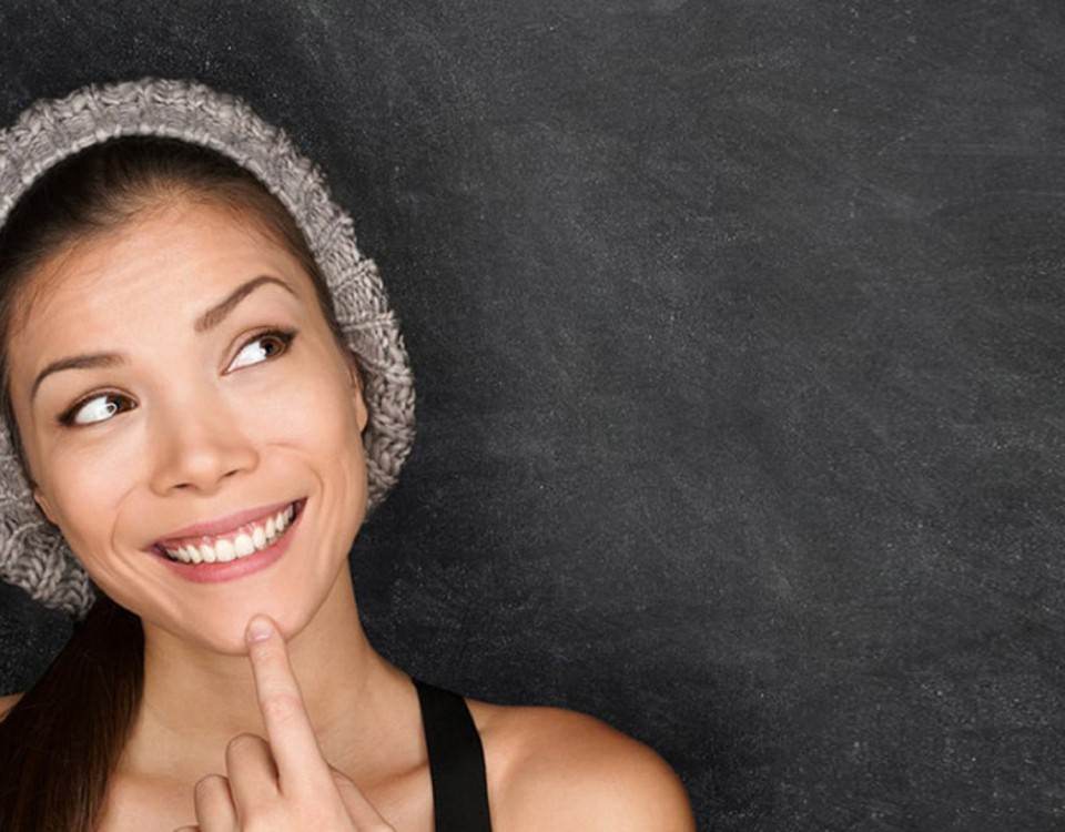 Woman resting a finger on her cheek, thinking