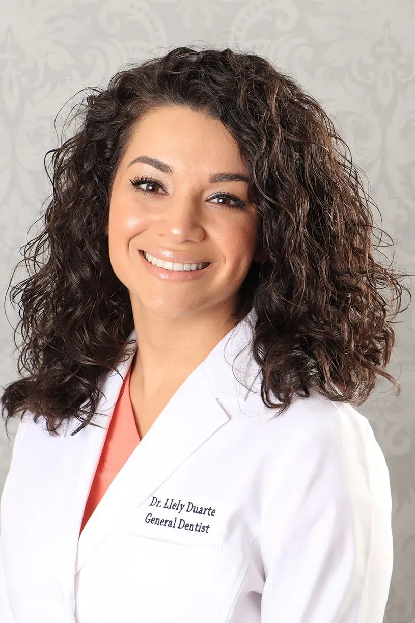 Studio portrait of Dr. Llely Duarte in a white coat