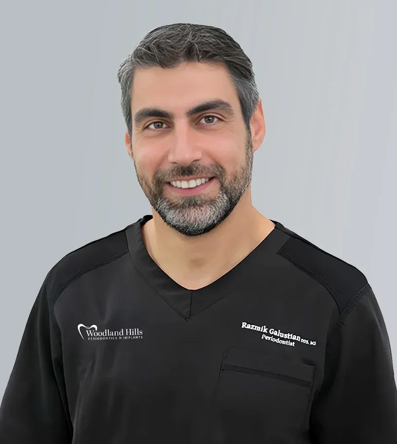Studio portrait of Dr. Razmik Galustian in black scrubs