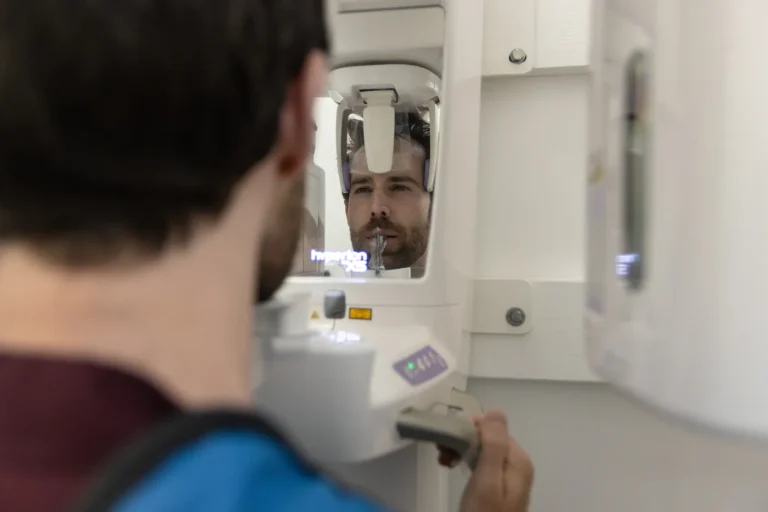 A patient positioned in the panoramic X-ray machine