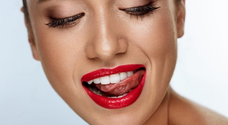 Close-up of bright white teeth framed by red lipstick